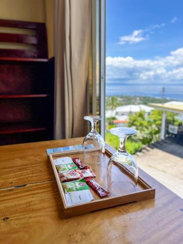 a glass tray with two wine glasses on top of a table at Seaview Mansion Dalaguete - Apartment 5 in Dalaguete