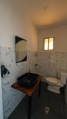 a bathroom with a black sink and a toilet at Seaview Mansion Dalaguete - Apartment 5 in Dalaguete