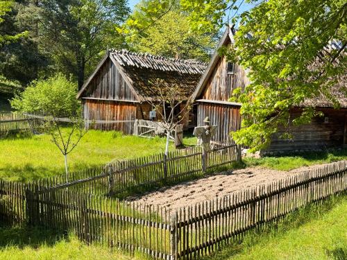 an old wooden house with a fence in front of it at Forest Mood in Wieck