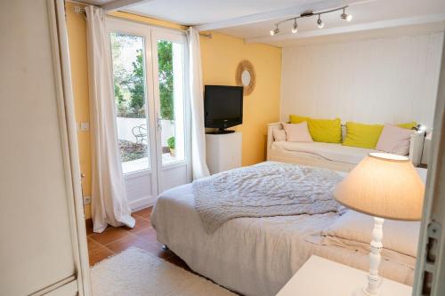 une chambre avec un lit, une télévision et une fenêtre dans l'établissement Maison de Rêve-Piscine-Activités-Vue Imprenable, à Grambois