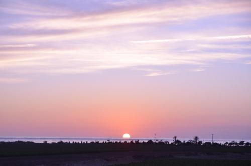 a sunset over the ocean with the sun in the sky at GIARDINO del MARE in Petrosino