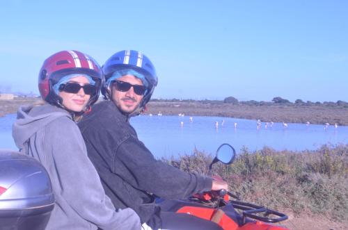 a man and woman riding on a motorcycle by the water at GIARDINO del MARE in Petrosino