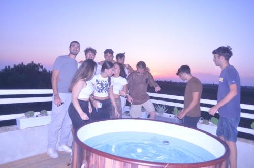 a group of people standing around a hot tub at GIARDINO del MARE in Petrosino