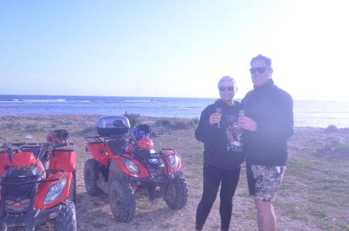 a man and a woman standing next to their motorcycles at GIARDINO del MARE in Petrosino