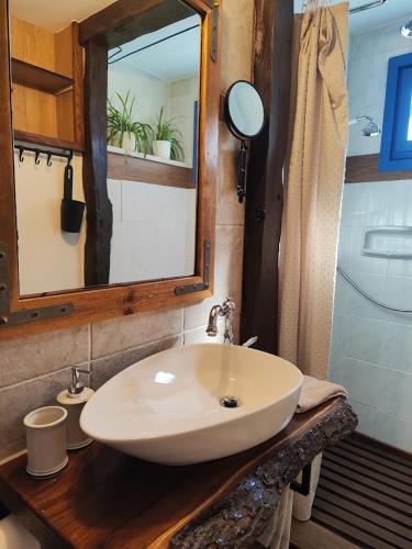 a bathroom with a white sink and a mirror at Casa Delle Olive in Mošćenička Draga