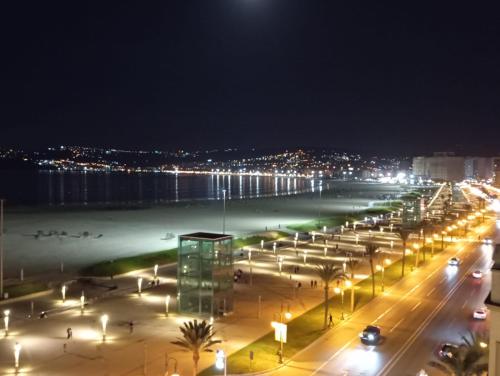 a view of a beach at night with street lights at Hotel Miramar in Tangier