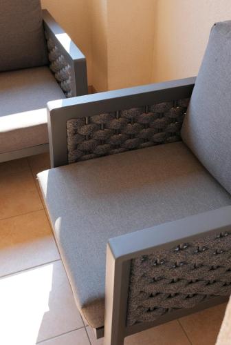 a bench in a room with two beds at Pension zur Sonne in Illmitz