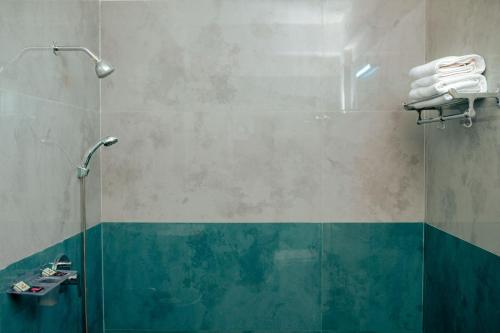 a bathroom with a shower with blue and green at Hotel Elite Fortune Inn in Tirupati