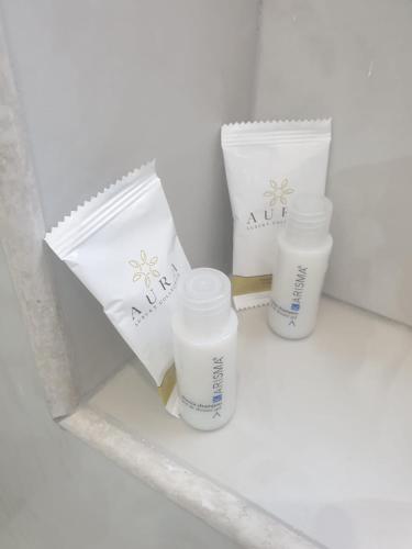 two bottles of milk and two cups on a shelf at La Perla dell' Adriatico Apartments - Perla Aurea - in Termoli