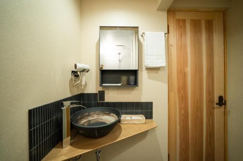 a bathroom with a sink and a mirror at 久宿 東山 Hisaya Higashiyama Room C in Kyoto