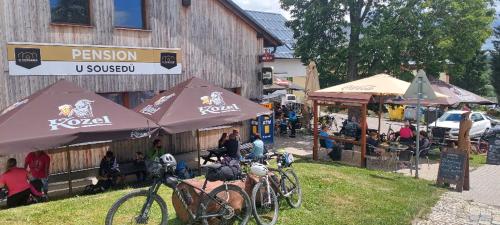 a group of bikes parked in front of a building at Penzion a Restaurace u Sousedů in Strážný