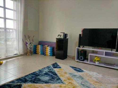a living room with a flat screen tv and a rug at Blue Petals Homestays in Nanyuki