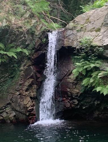 a waterfall on the side of a rock wall at Mono Ele a Varigotti in Varigotti