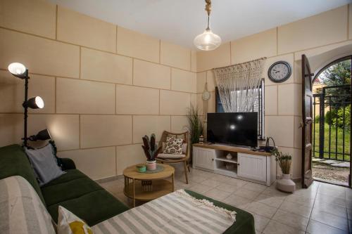 a living room with a couch and a tv at iriada house in Rhodes Town