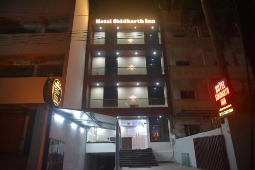 a hotel building with a sign on top of it at Hotel Siddharth Inn, Raipur Junction in Raipur