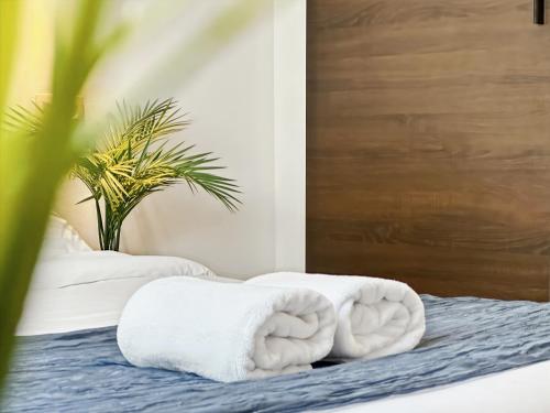 a bed with two towels on top of it at Hatton - 650m do plaży ! in Grzybowo