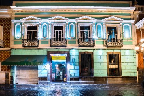 a building with blue lights on a street at Casona Poblana Hotel Puebla in Puebla