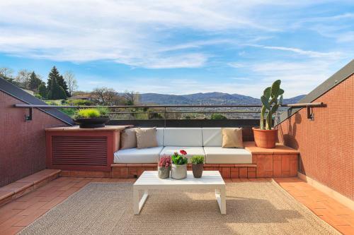 a white couch on a balcony with a table at Casa Giacomo in Arona