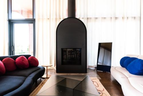 a living room with two couches and a fireplace at Tsinandali Estate, A Radisson Collection Hotel in Tsinandali