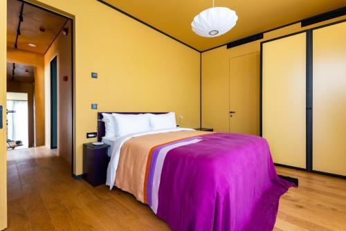 a bedroom with a large bed with a pink blanket at Tsinandali Estate, A Radisson Collection Hotel in Tsinandali