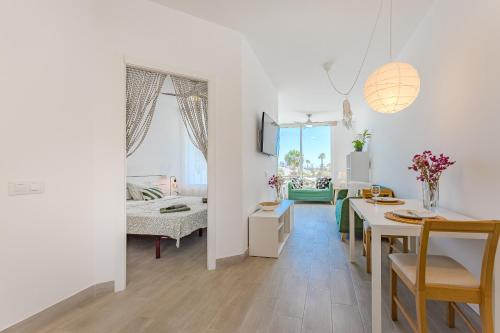 a kitchen and dining room with a table and a dining room at Luz de la Luna - Ocean View - Las Americas in Costa de Adeje