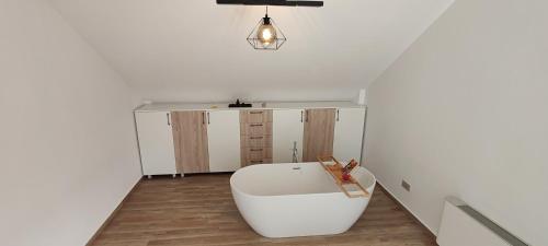 a living room with a white couch and a table at INDRA WELLNESS Retreats and Spa in Samurcaşi