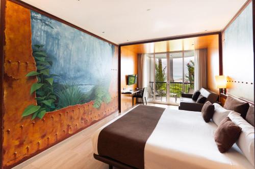 a bedroom with a large bed with a large painting on the wall at Estela Barcelona in Sitges