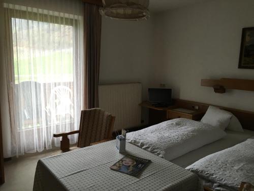 a hotel room with two beds and a window at Hubergut Appartements in Radstadt