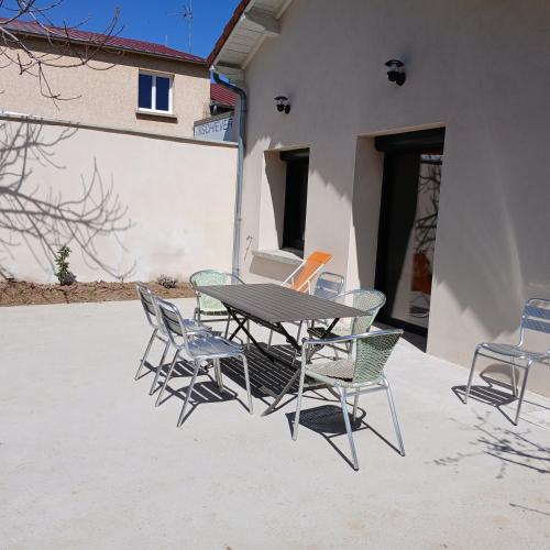 a table and chairs sitting on a patio at L'Atelier in Maclas