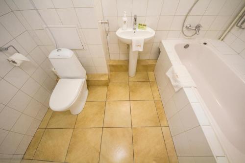 a bathroom with a toilet and a sink at Cheap Apartments in Kyiv