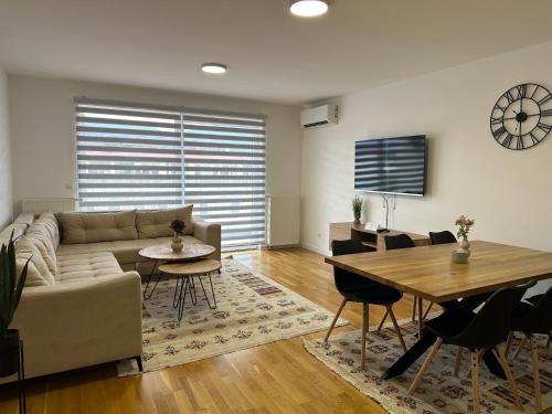 a living room with a couch and a table at ZORA apartmani Sarajevo in Sarajevo