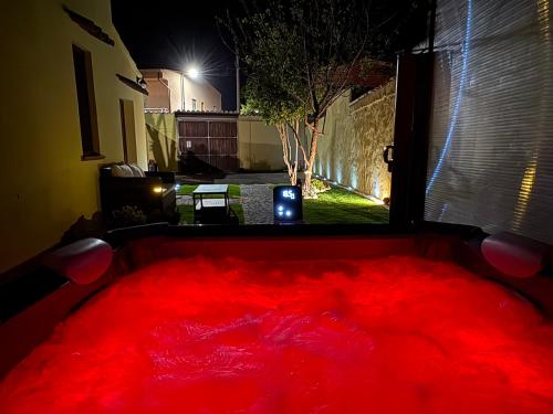 a large red floor in a room with a window at Costa Ovest Apartment 2 in Nurachi