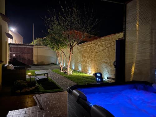 a hot tub in a backyard at night at Costa Ovest Apartment 2 in Nurachi