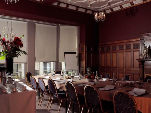 a conference room with a long table and chairs at The Crown Hotel in Harrogate
