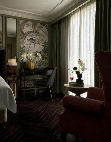 a living room with a piano and a table at Signature by M Village Hai Bà Trưng in Ho Chi Minh City