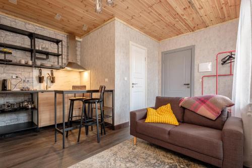a living room with a couch and a kitchen at Dacha Apart Hotel in Jūrmala