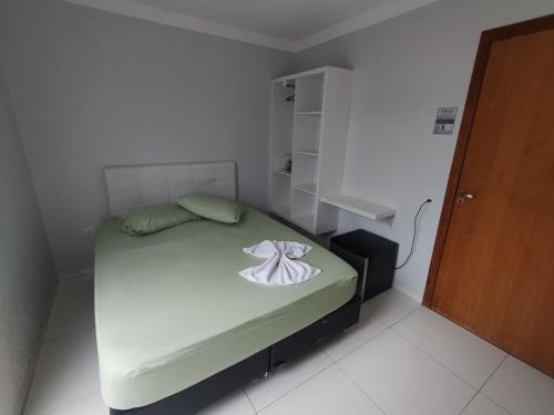 a small bedroom with a bed in a room at Suíte Privativa no Residencial Vitória - 11 in Guaíra