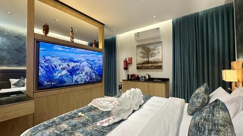 a bedroom with a large tv and a bed at Mehad Stay for Self Check-In Apartment in Jeddah
