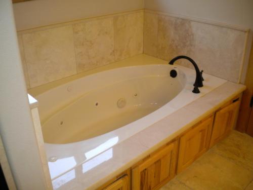 a white bath tub in a bathroom with a counter at Close To Everything Newly Built With Games Room in South Lake Tahoe