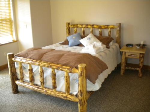 a bedroom with a bed with a wooden frame at Close To Everything Newly Built With Games Room in South Lake Tahoe