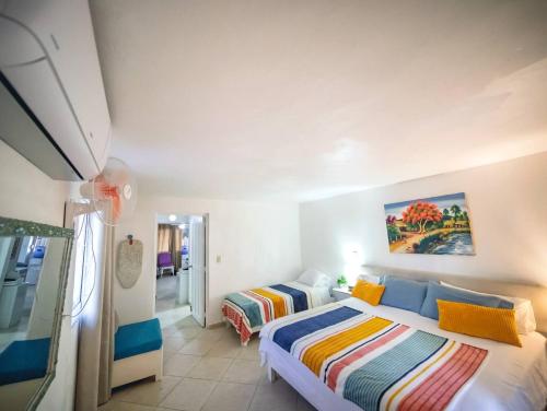 a bedroom with two beds in a room at Central 1BR APT - 1 minute Walking from Rumba in Sosúa