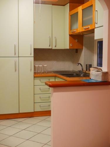 a kitchen with white cabinets and a counter top at Riva RomAntica in Lido dei Pini