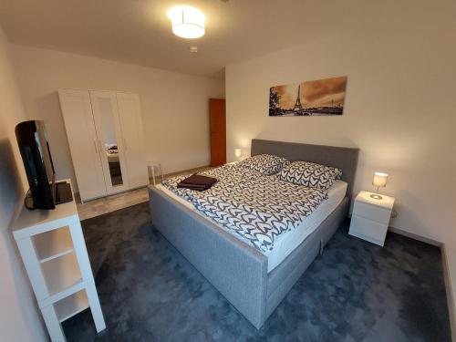 a bedroom with a bed and a television in it at Ferienwohnung No 9 in Hameln in Hameln