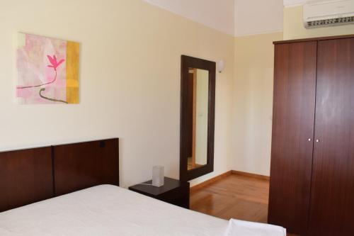 a bedroom with a bed and a wooden cabinet at Douro Natura in Bemposta