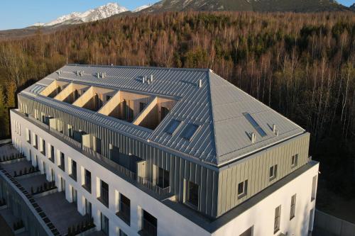 an aerial view of a building with a roof at TATRYSTAY Lebenski Premium Apartments in Vysoké Tatry
