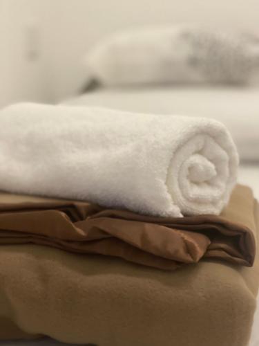 a white towel is sitting on top of towels at Heritage House 123 in George Town