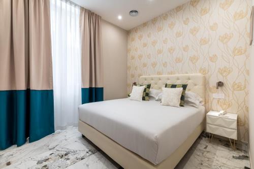 a bedroom with a white bed and a window at 69 Suite Boutique in Rome