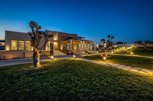 a house with lights in front of it at night at Shalamu Luxury Apartments in Rosolini