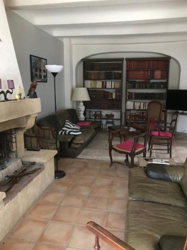 a living room with a couch and a fireplace at La colonie in Servas