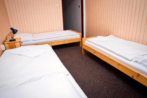 a room with two beds in a room at Hotel Zimní stadion Náchod in Náchod